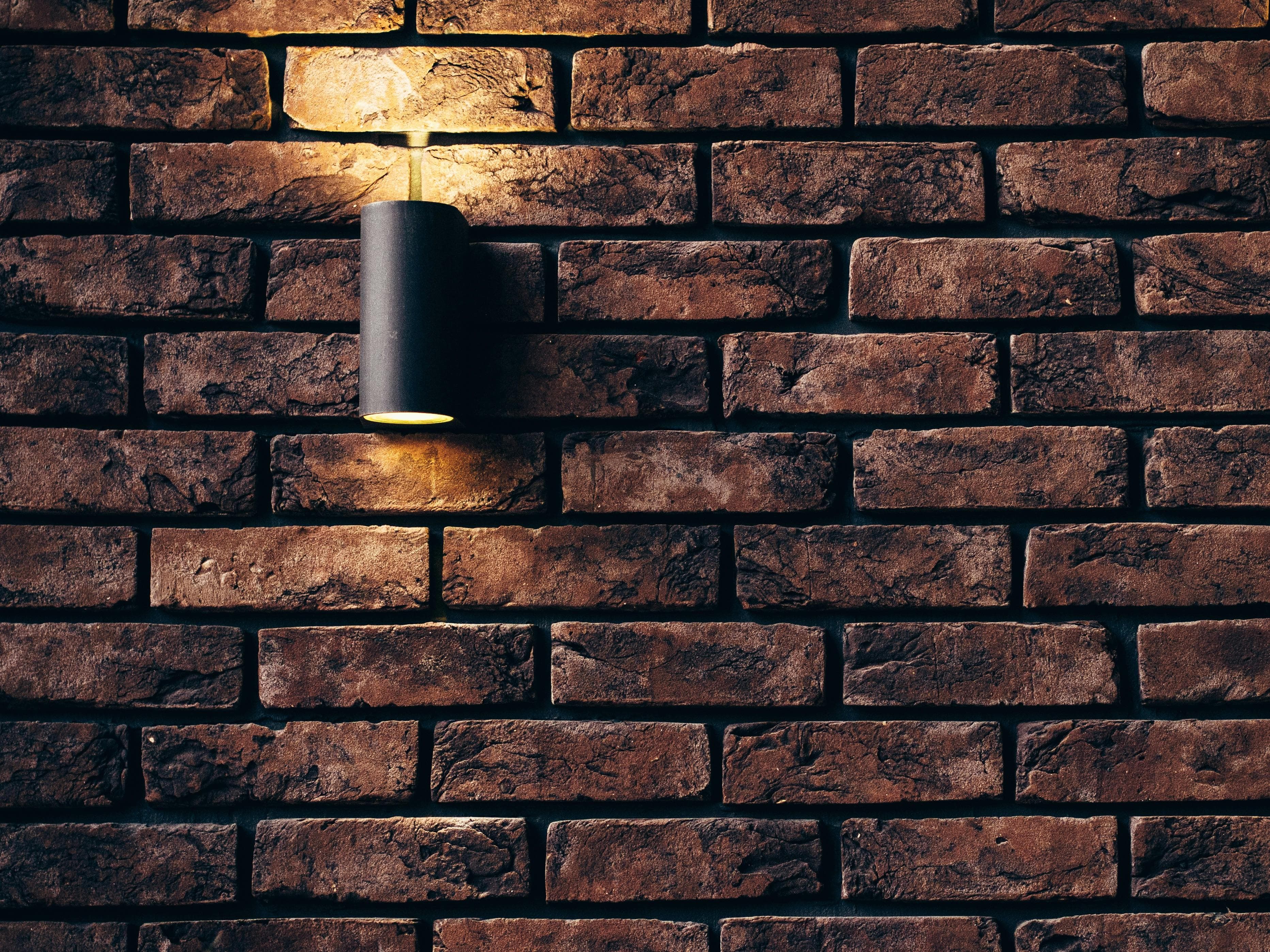 Refrigerant line concealment within brick wall